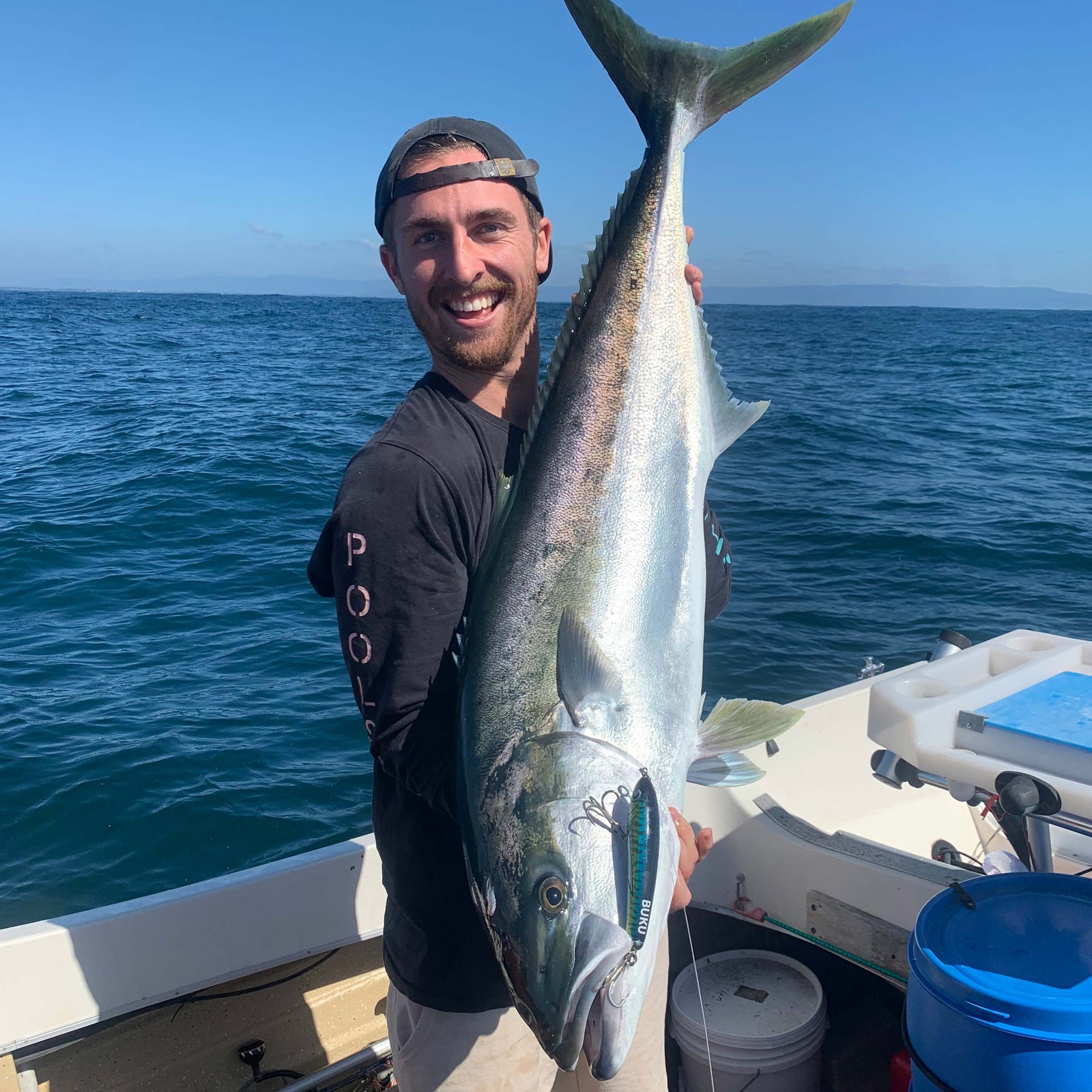 Mitch holding a kingfish with a buku fast sink p stick bait